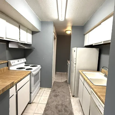 a kitchen with a stove and a refrigerator