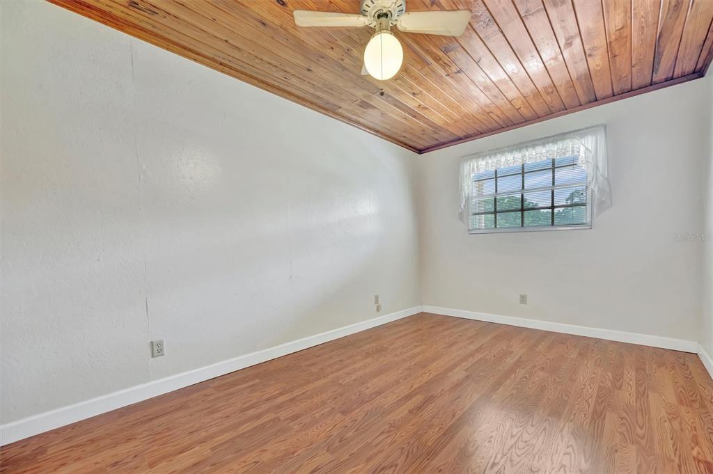 7015 Spears Road Plant City, FL 33567 - Photo 15 of 77 an empty room with wooden floor and windows