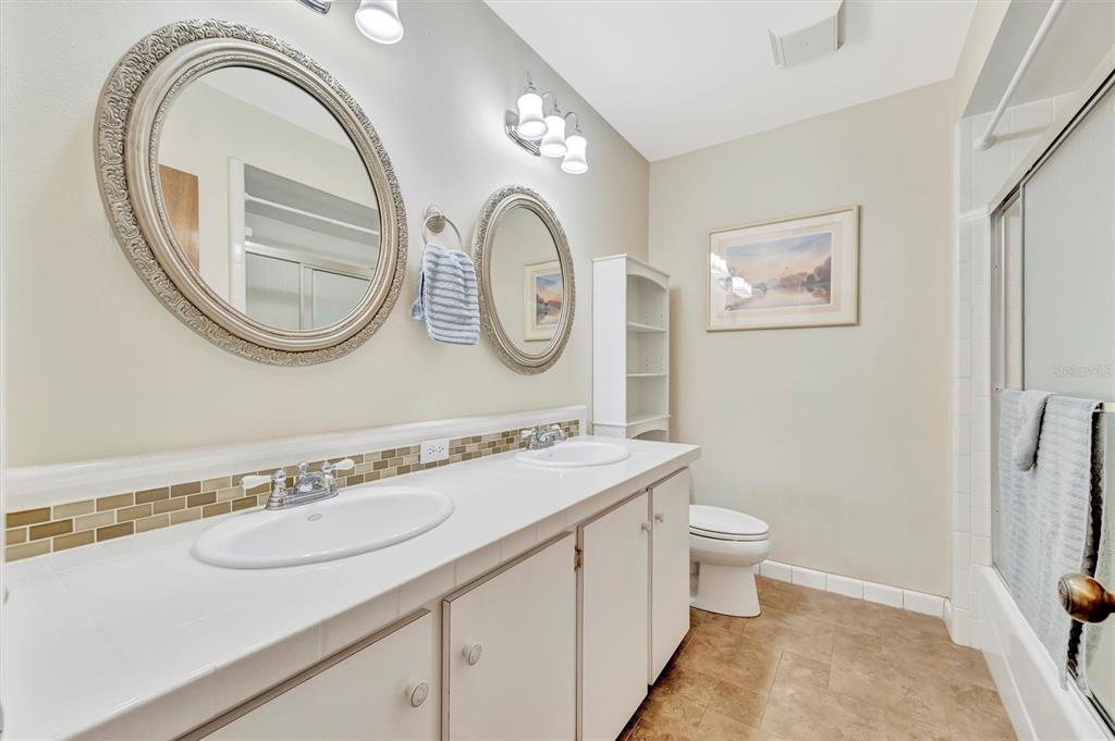 7015 Spears Road Plant City, FL 33567 - Photo 16 of 77 a bathroom with a toilet a sink and a mirror