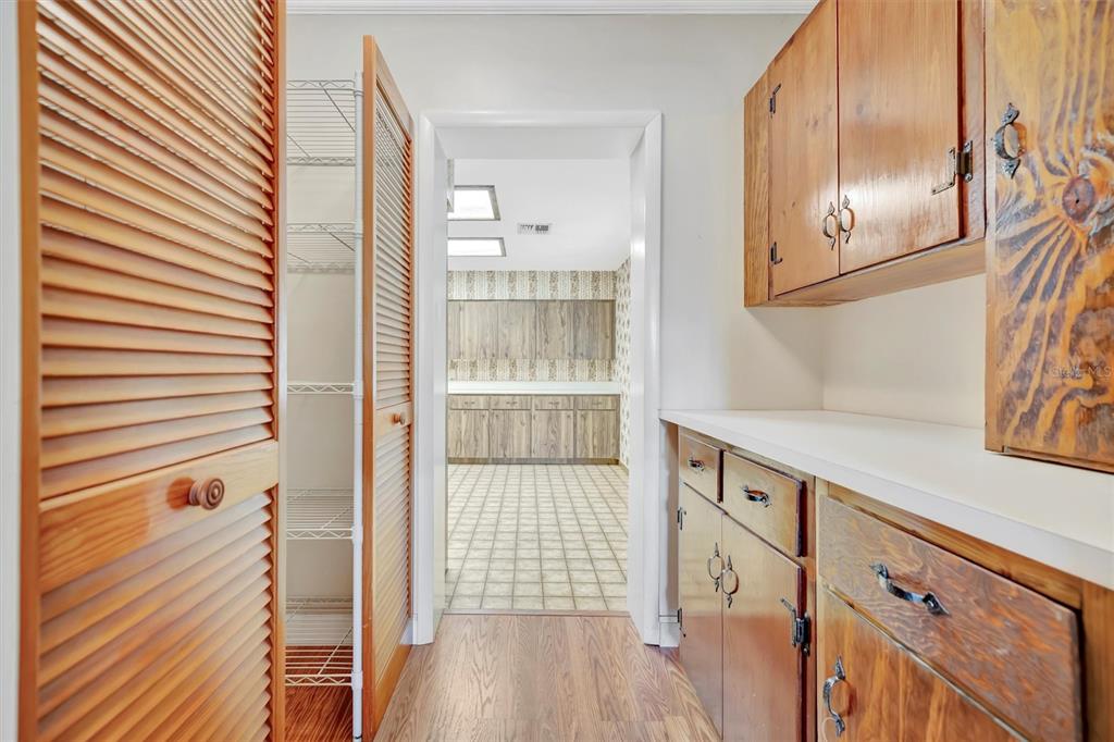 7015 Spears Road Plant City, FL 33567 - Photo 30 of 77 a view of a kitchen cabinets and wooden floor