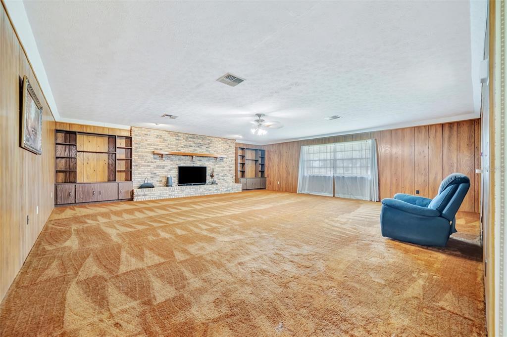 7015 Spears Road Plant City, FL 33567 - Photo 33 of 77 a view of an empty room with a fireplace and a window