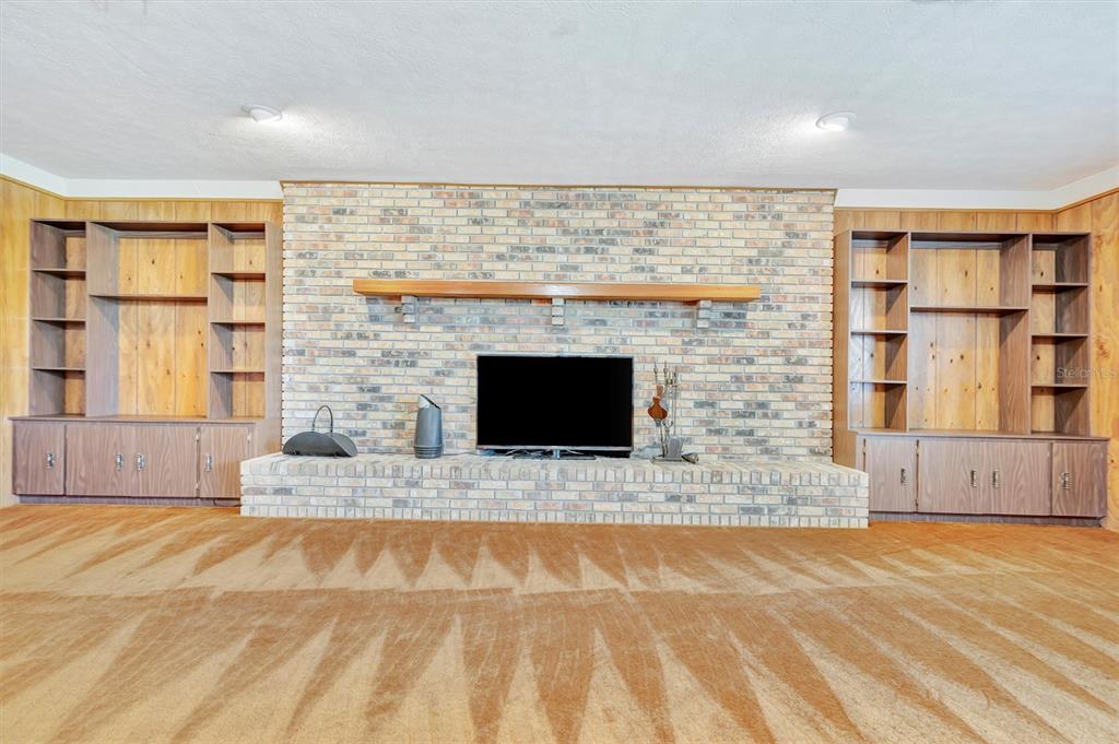 7015 Spears Road Plant City, FL 33567 - Photo 36 of 77 a view of an empty room with a fireplace and a window
