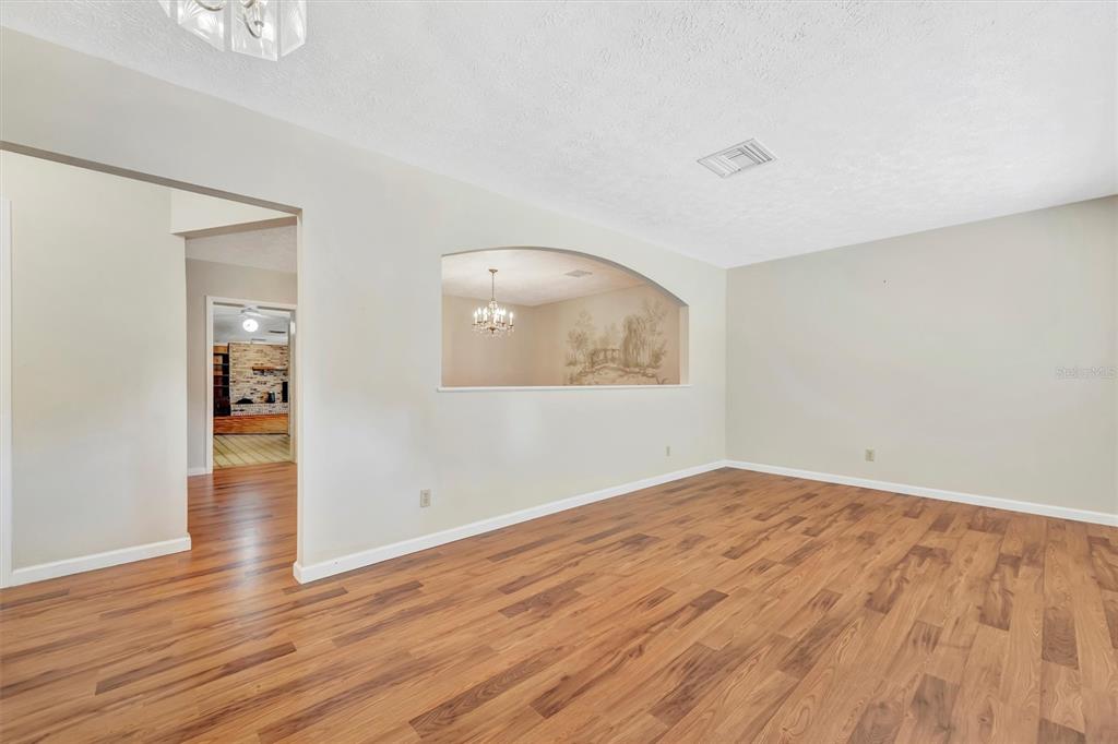 7015 Spears Road Plant City, FL 33567 - Photo 4 of 77 an empty room with wooden floor and windows