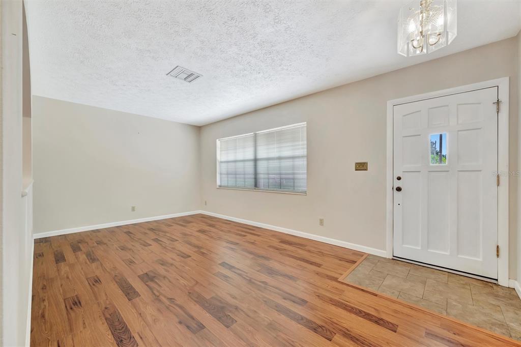 7015 Spears Road Plant City, FL 33567 - Photo 5 of 77 wooden floor in an empty room with a window