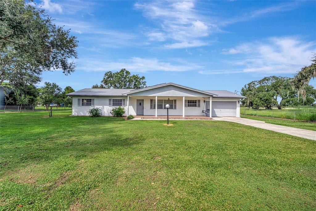 7015 Spears Road Plant City, FL 33567 - Photo 69 of 77 a front view of a house with a garden