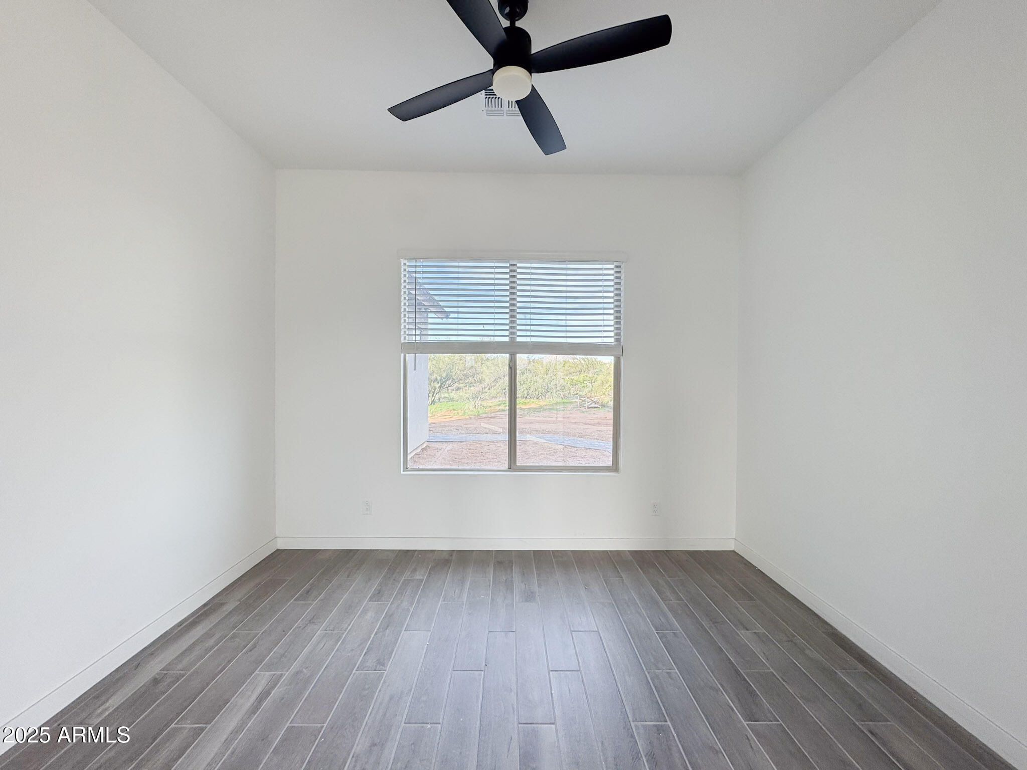 16143 East Lowden Court Scottsdale, AZ 85262 - Photo 13 of 20 an empty room with a window and a ceiling fan