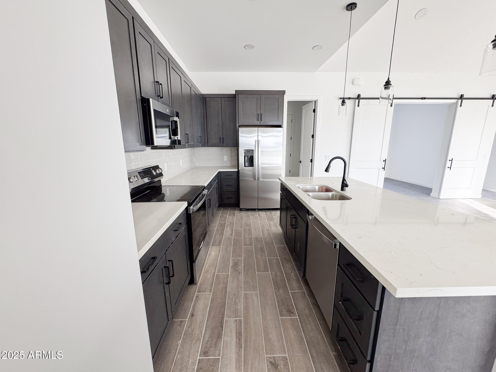 16143 East Lowden Court Scottsdale, AZ 85262 - Photo 7 of 20 a kitchen with sink a counter top space and stainless steel appliances