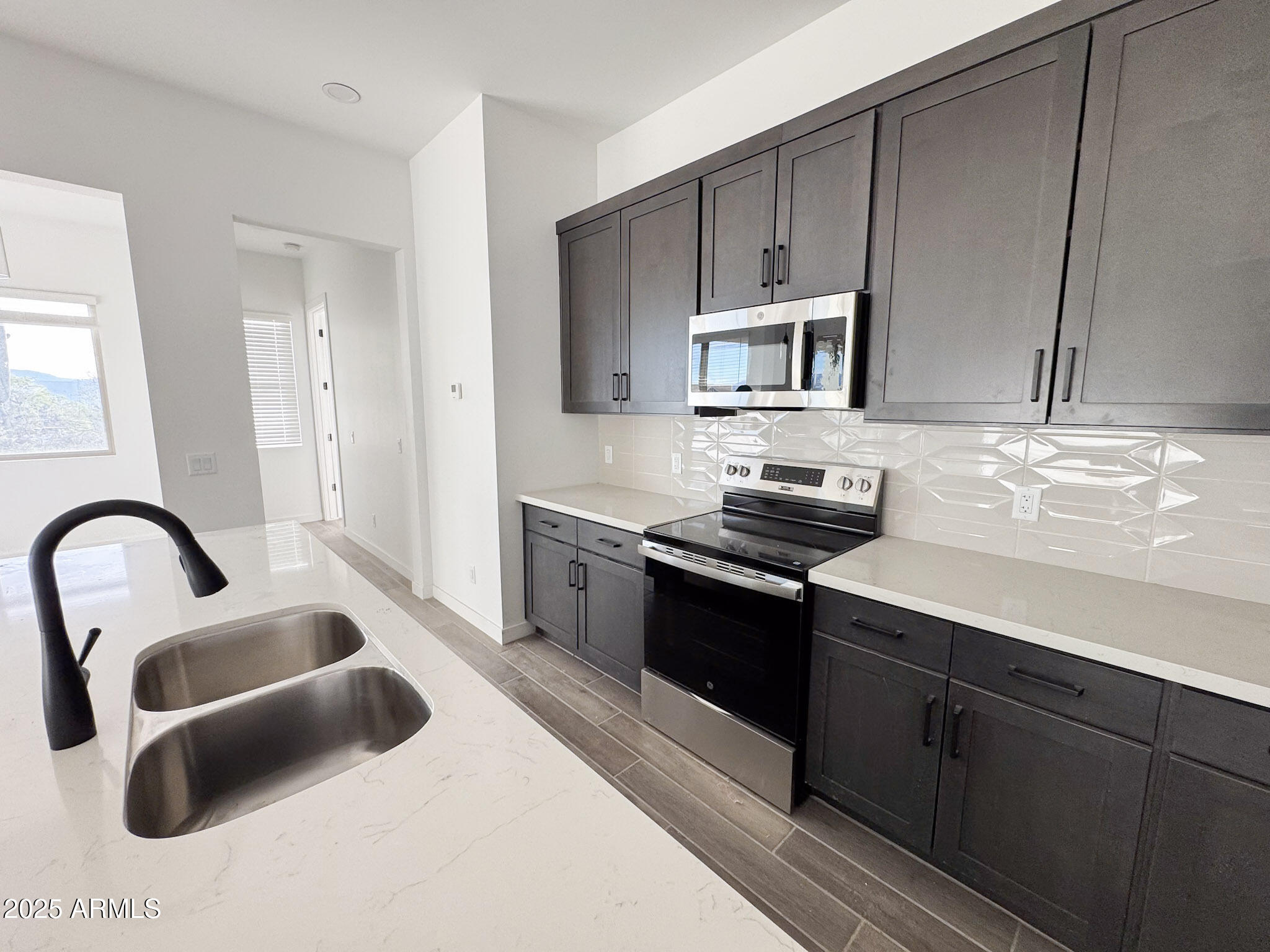 16143 East Lowden Court Scottsdale, AZ 85262 - Photo 9 of 20 a kitchen with granite countertop a stove and a sink
