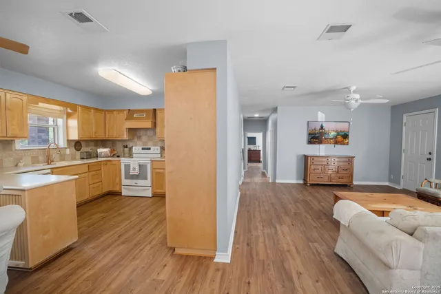 a kitchen with stainless steel appliances wooden floors and refrigerator