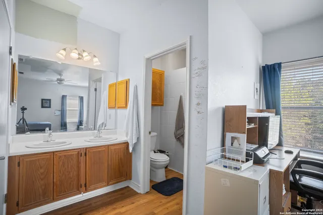 a bathroom with a sink a toilet and mirror