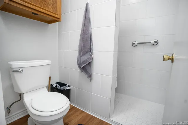 a white toilet sitting next to a bath tub