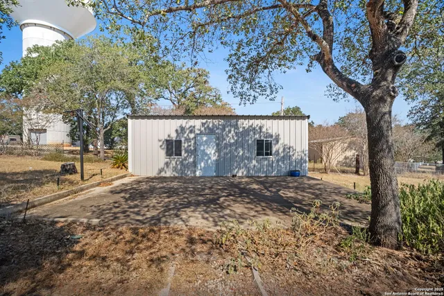 a view of a yard with wooden fence