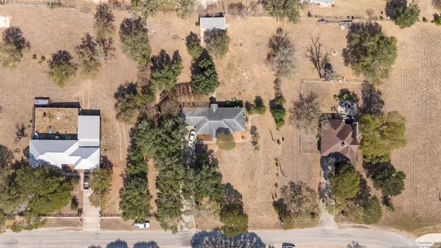 an aerial view of a house with a yard