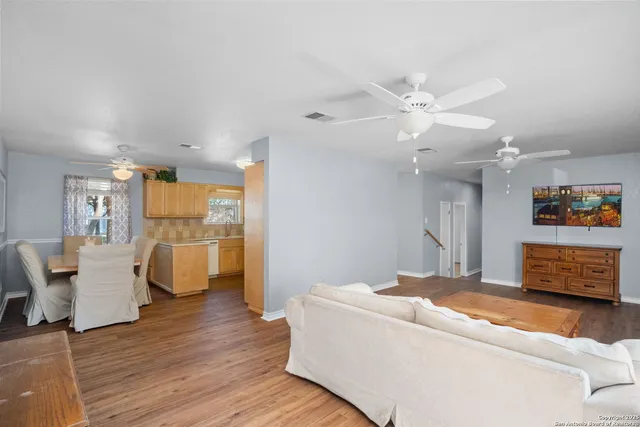 a living room with furniture and wooden floor