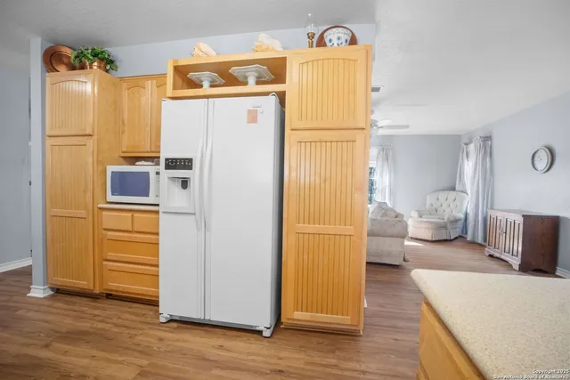 a bedroom with a refrigerator and a more cabinets