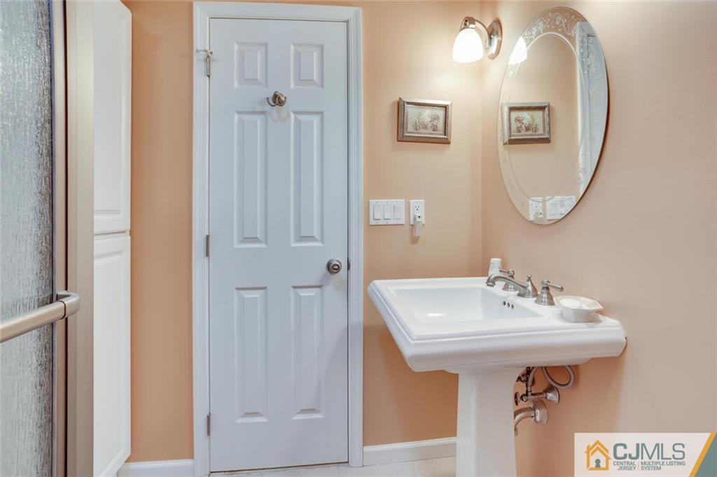 220 Biscayne Road Barnegat, NJ 08005 - Photo 22 of 37 a bathroom with a sink and a mirror