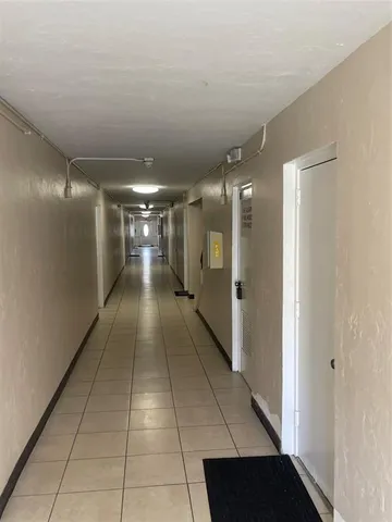 an empty room with white walls and tiles