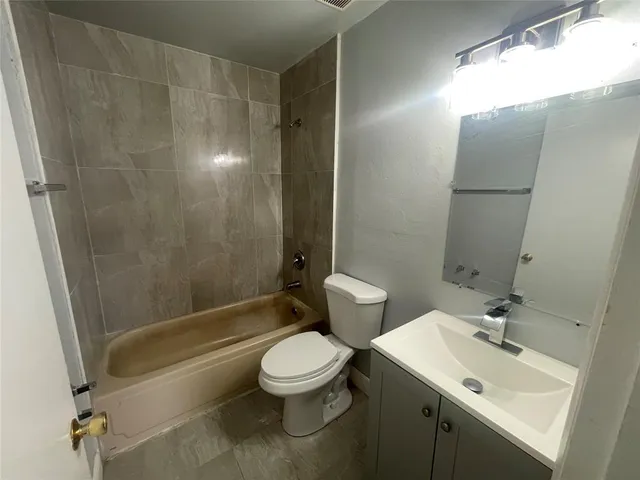 en empty room with windows and fan