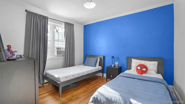 a bedroom with two beds and a window