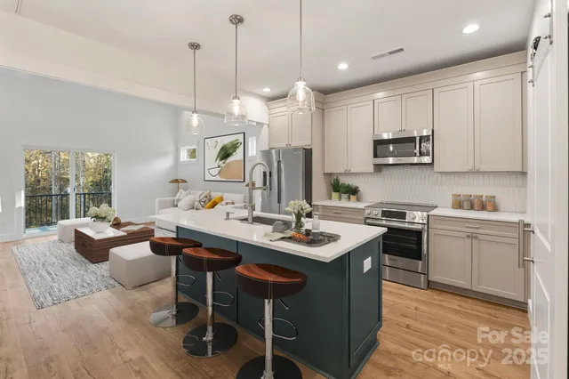 a kitchen with kitchen island granite countertop a sink counter top space appliances and cabinets