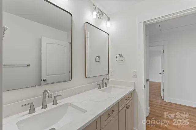 a bathroom with a sink double vanity and a mirror