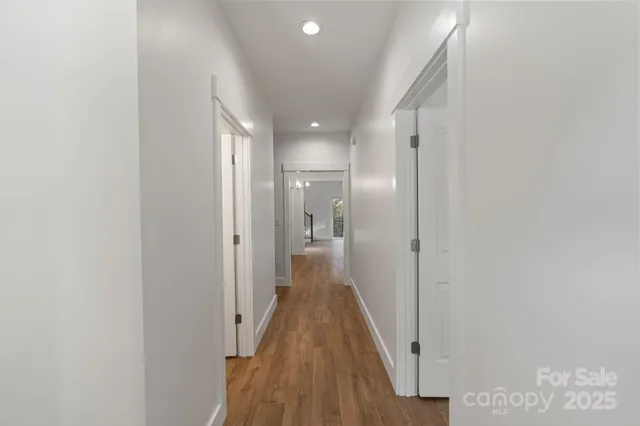 a view of a hallway with wooden floor