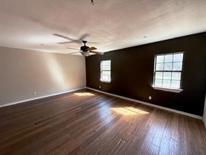 426 Gun Club Road Denison, TX 75021 - Photo 7 of 20 a view of an empty room with wooden floor and a window