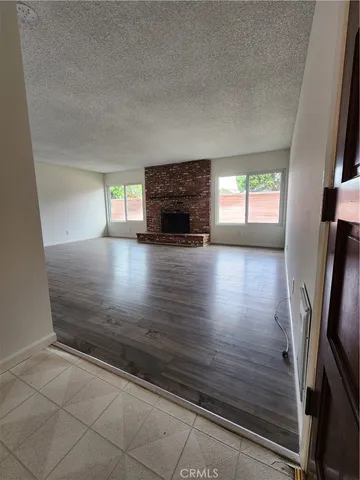 wooden floor in an empty room with a fireplace