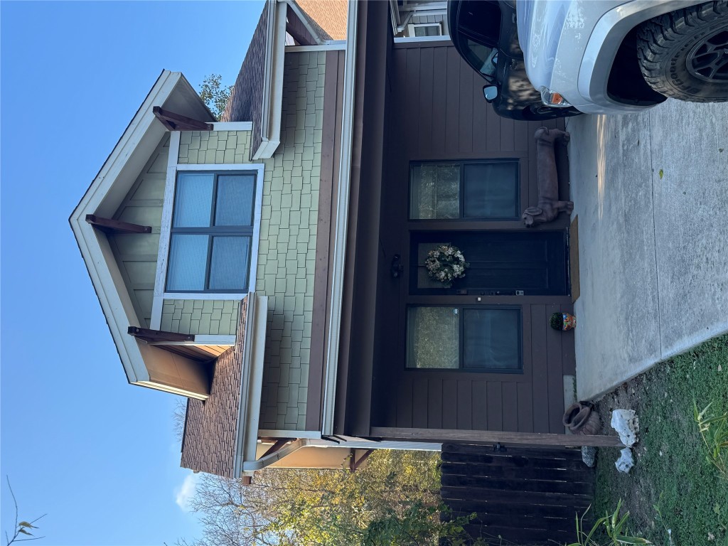 View of front facade featuring a shingled roof