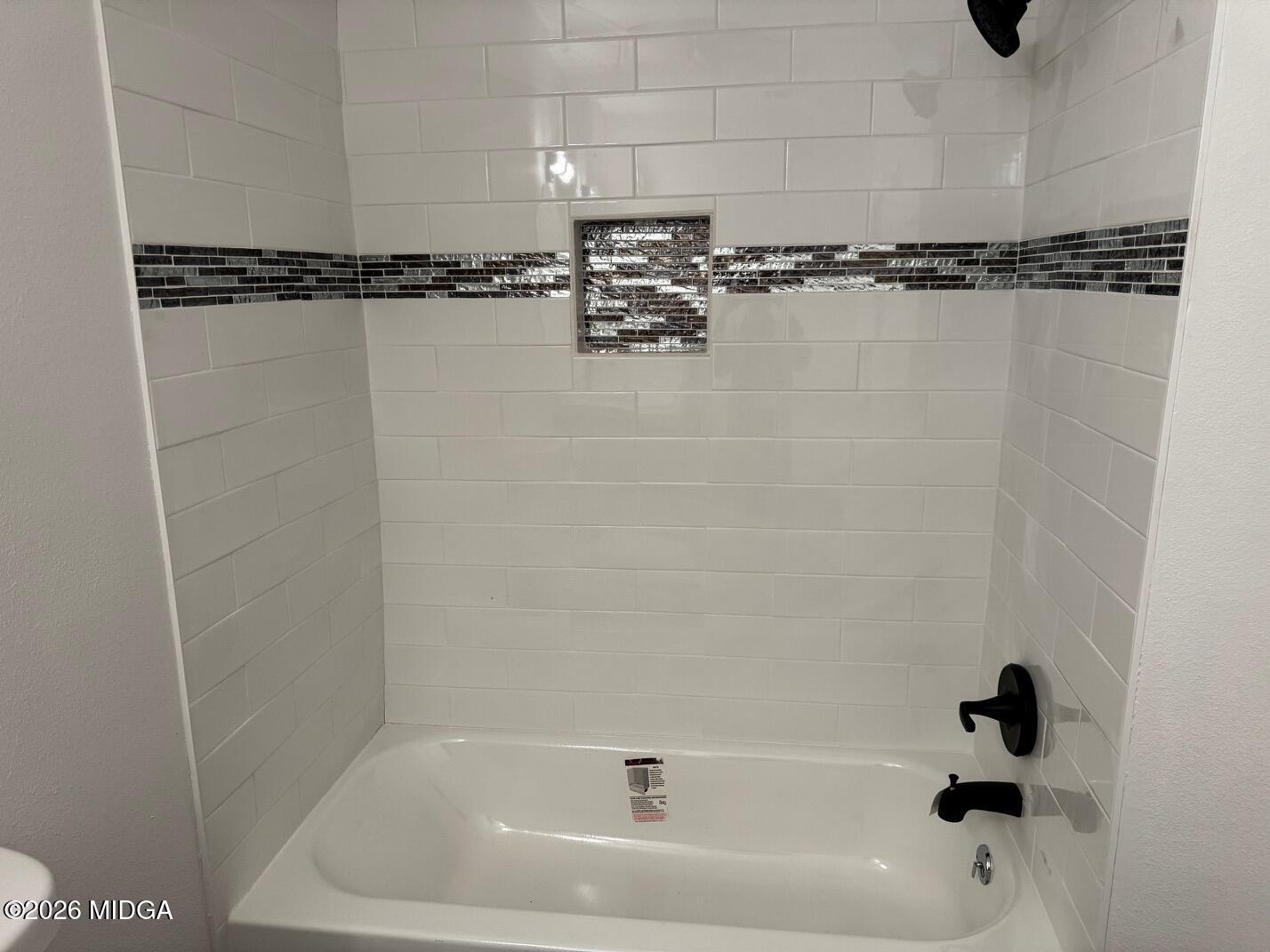4266 Mumford Road Macon, GA 31204 - Photo 14 of 17 a bathroom with a bathtub and a shower