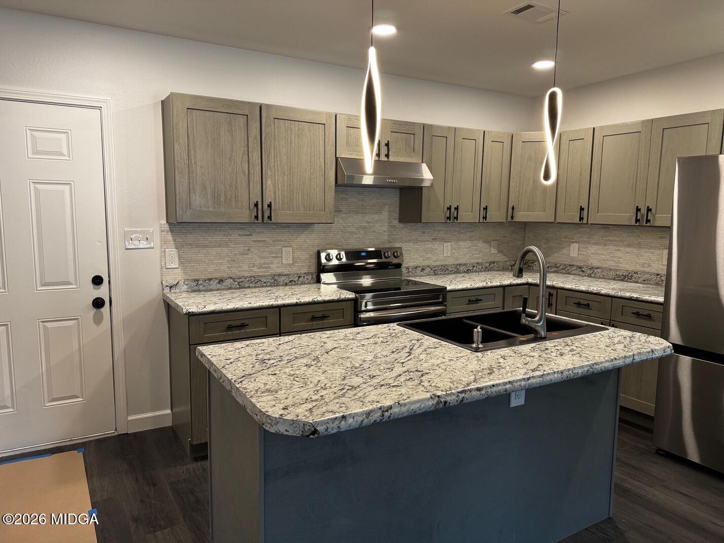 4266 Mumford Road Macon, GA 31204 - Photo 3 of 17 a kitchen with stainless steel appliances granite countertop a sink stove and refrigerator