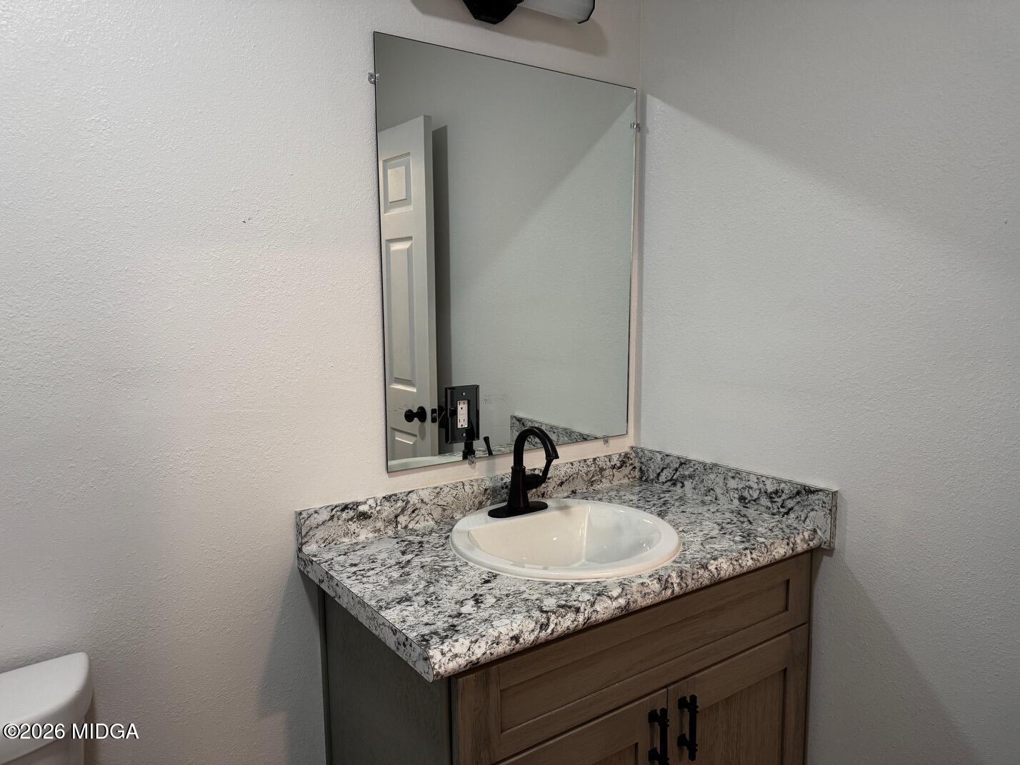 4266 Mumford Road Macon, GA 31204 - Photo 7 of 17 a sink and a mirror