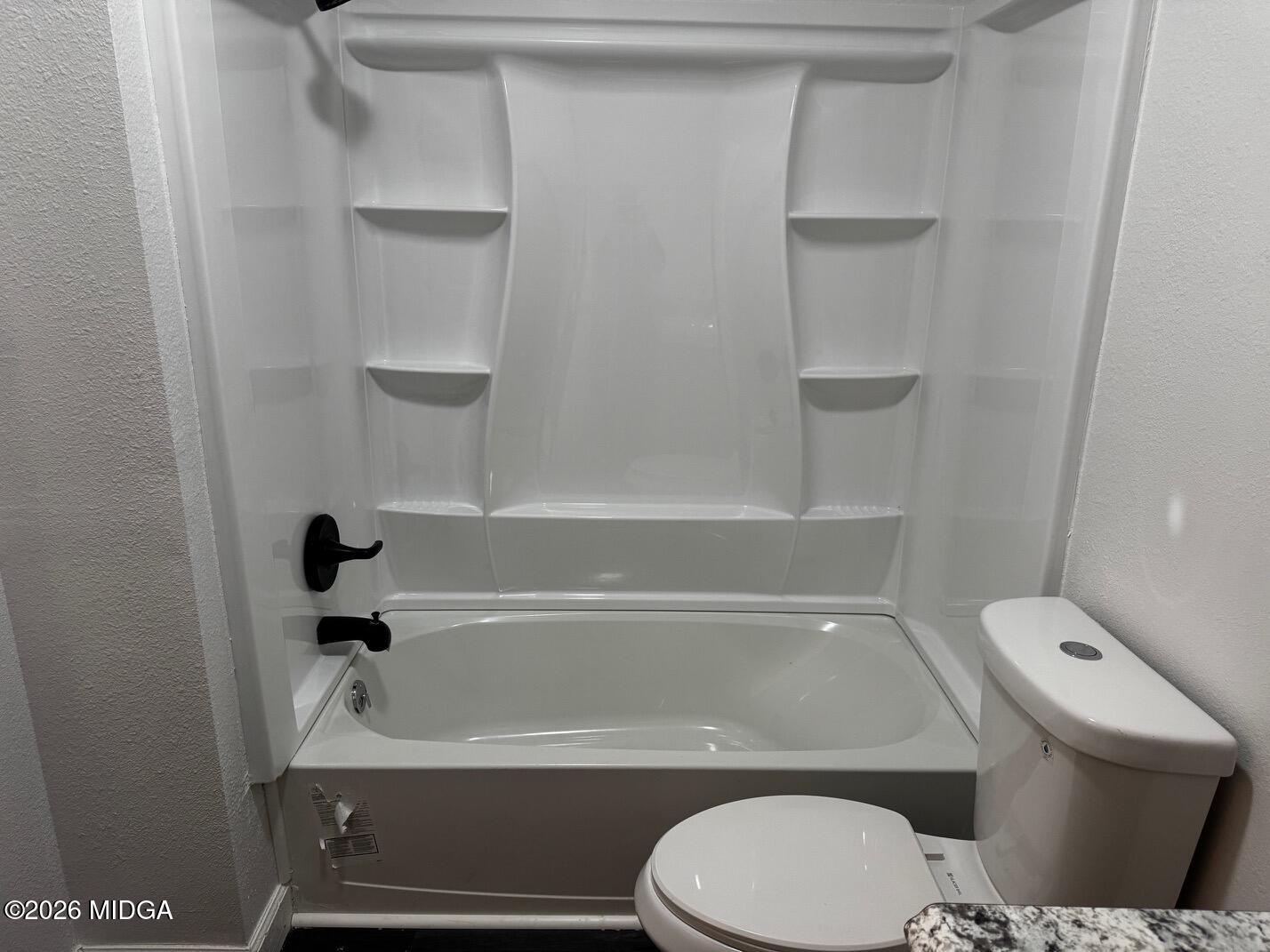 4266 Mumford Road Macon, GA 31204 - Photo 8 of 17 a bathroom with a toilet and a bathtub