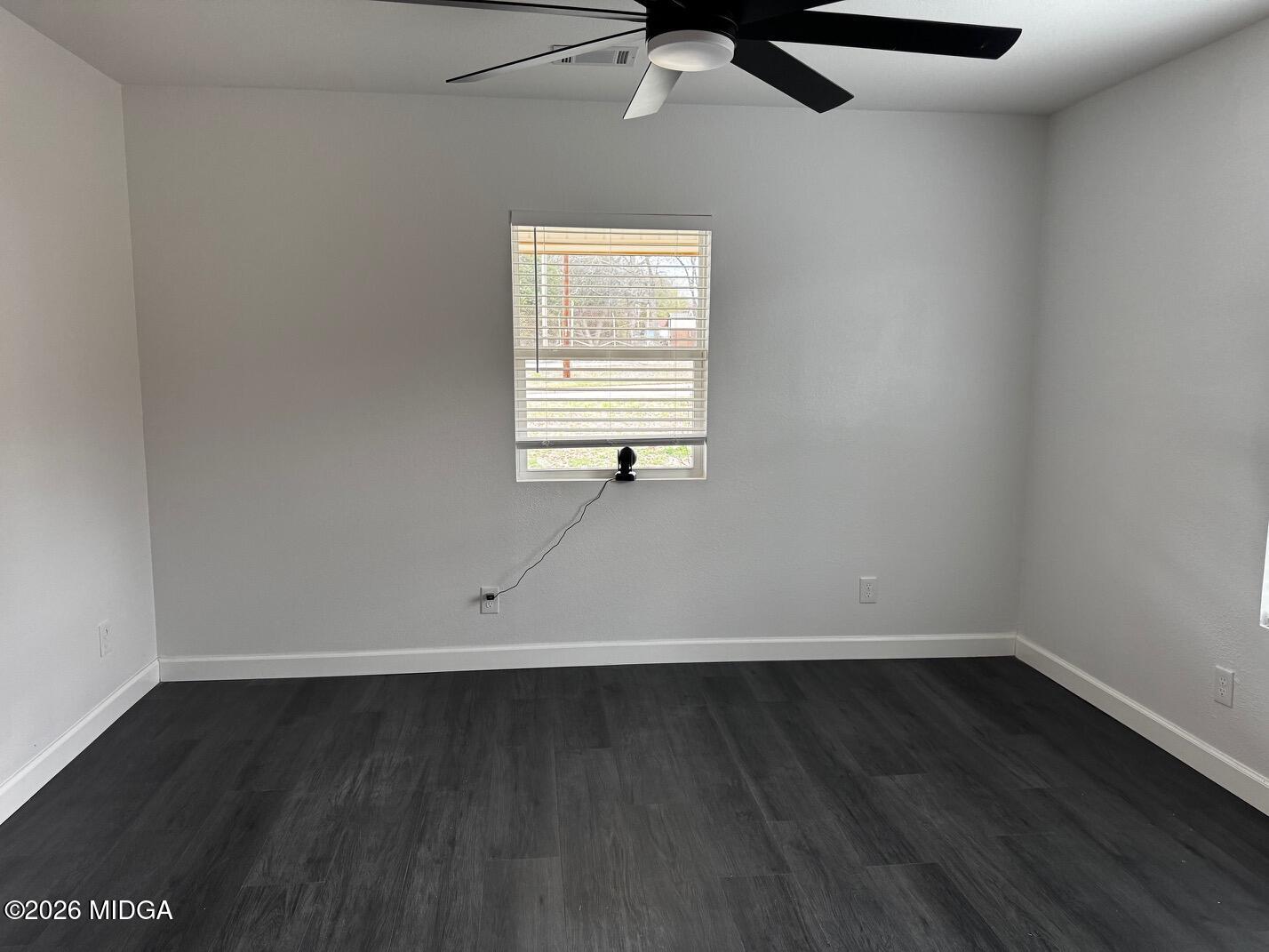 4266 Mumford Road Macon, GA 31204 - Photo 9 of 17 an empty room with wooden floor and windows