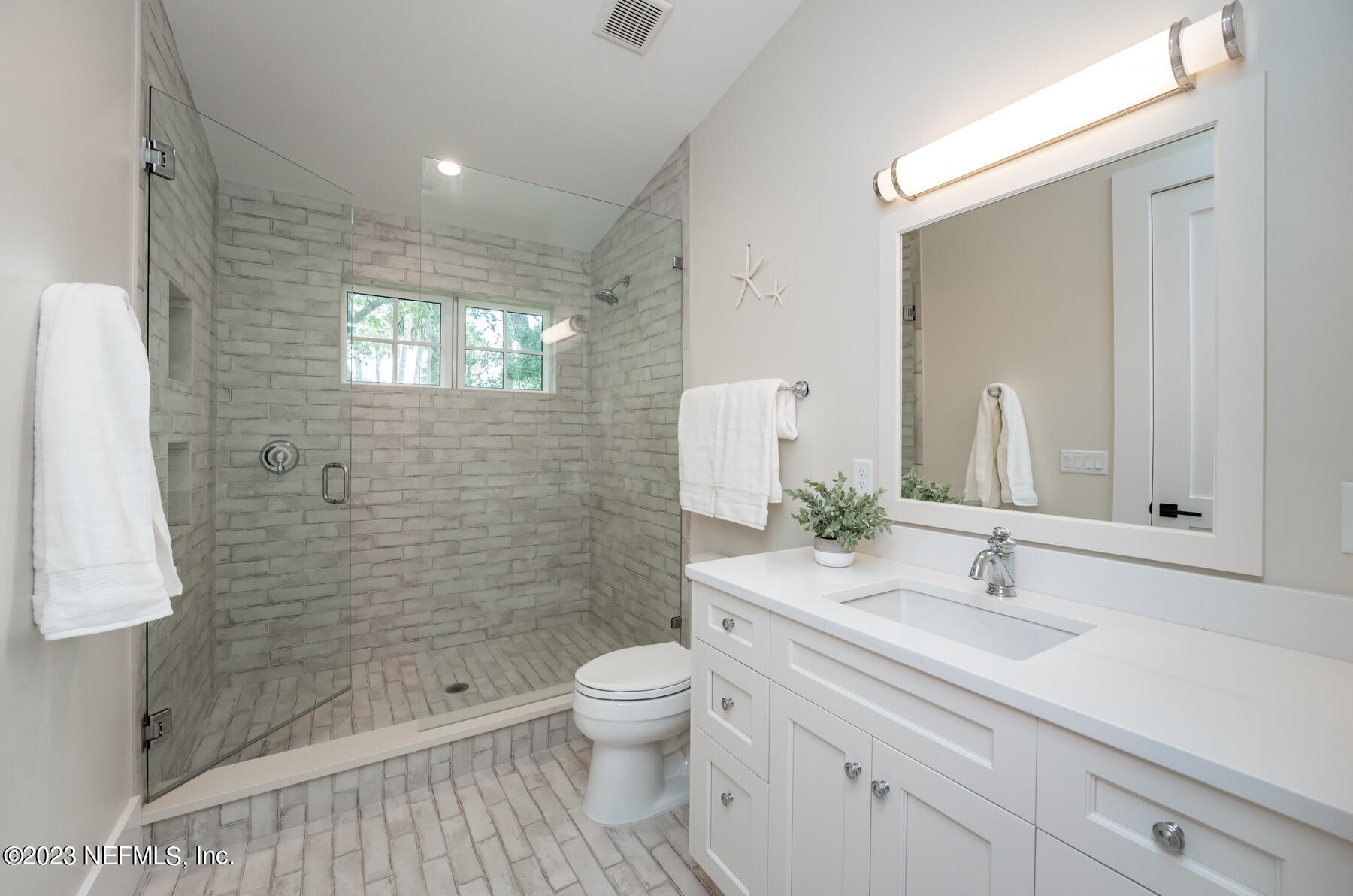 357 11th Street Atlantic Beach, FL 32233 - Photo 27 of 47 a bathroom with a sink a toilet and shower