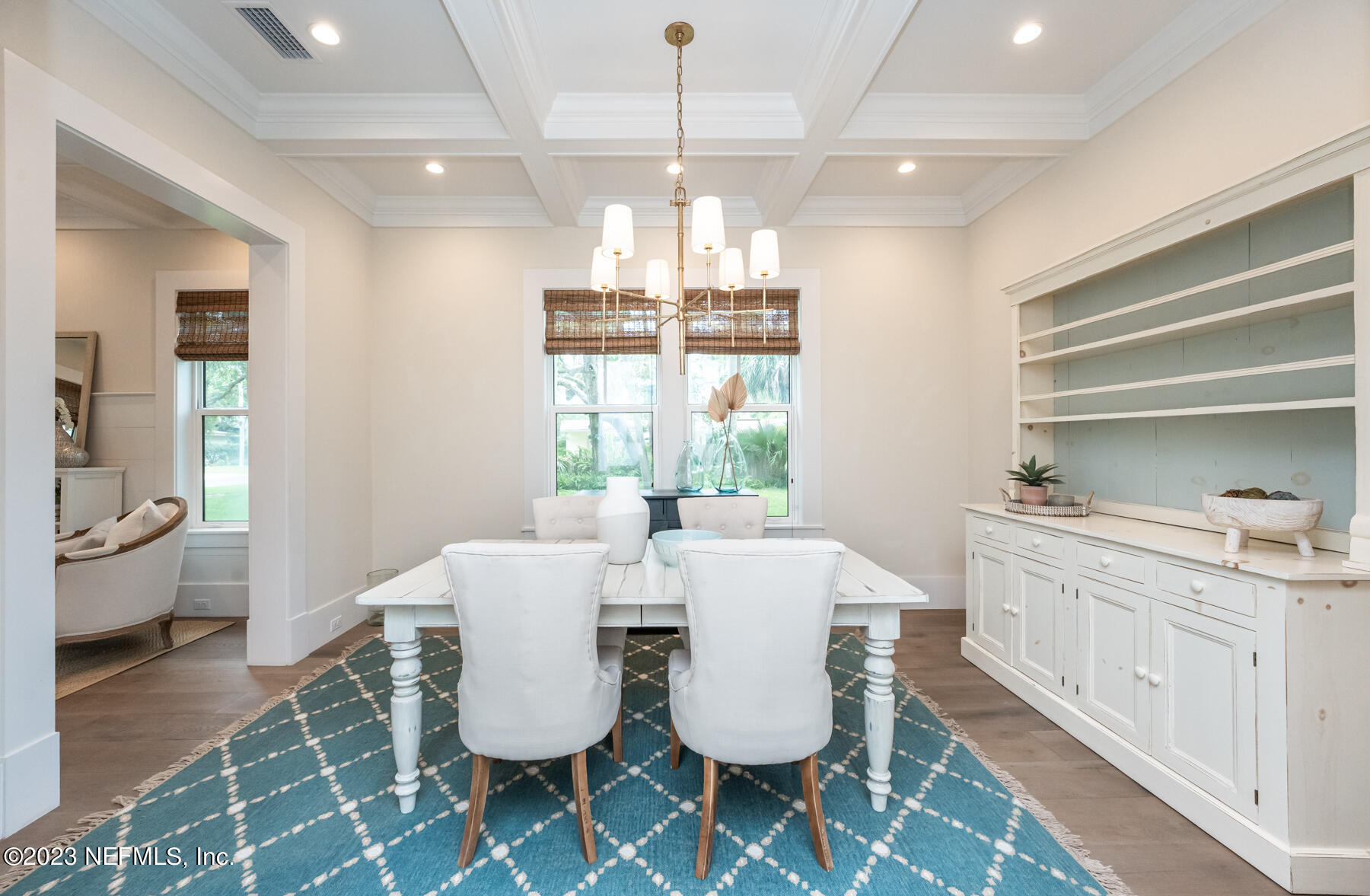357 11th Street Atlantic Beach, FL 32233 - Photo 6 of 47 a dining room with wooden floor and a chandelier