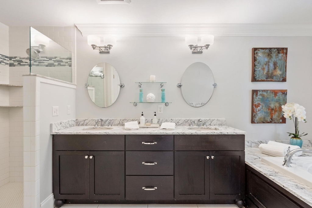 56 Old Marlboro Road Concord, MA 01742 - Photo 11 of 34 a bathroom with a double vanity sink and a mirror