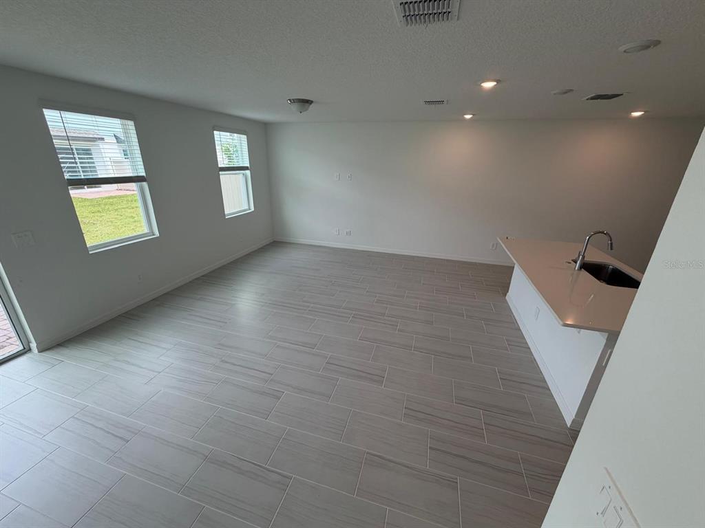 4256 Ranch House Road St. Cloud, FL 34772 - Photo 5 of 30 wooden floor in an empty room with a window