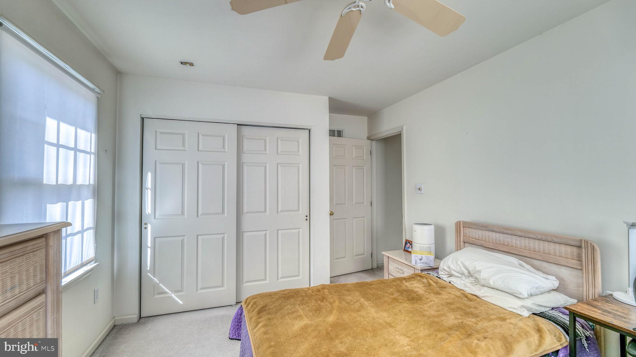 530 North Shore Road Marmora, NJ 08223 - Photo 13 of 31 a bedroom with a bed and a chandelier