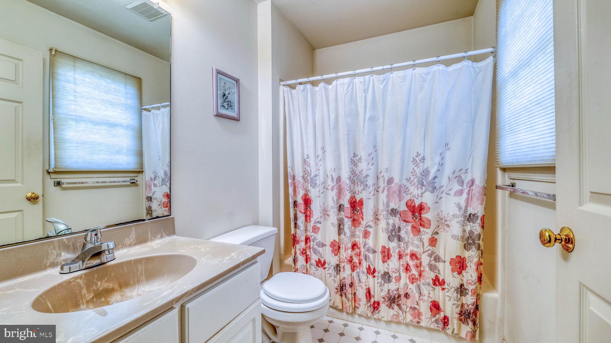 530 North Shore Road Marmora, NJ 08223 - Photo 17 of 31 a bathroom with a sink toilet and shower curtain