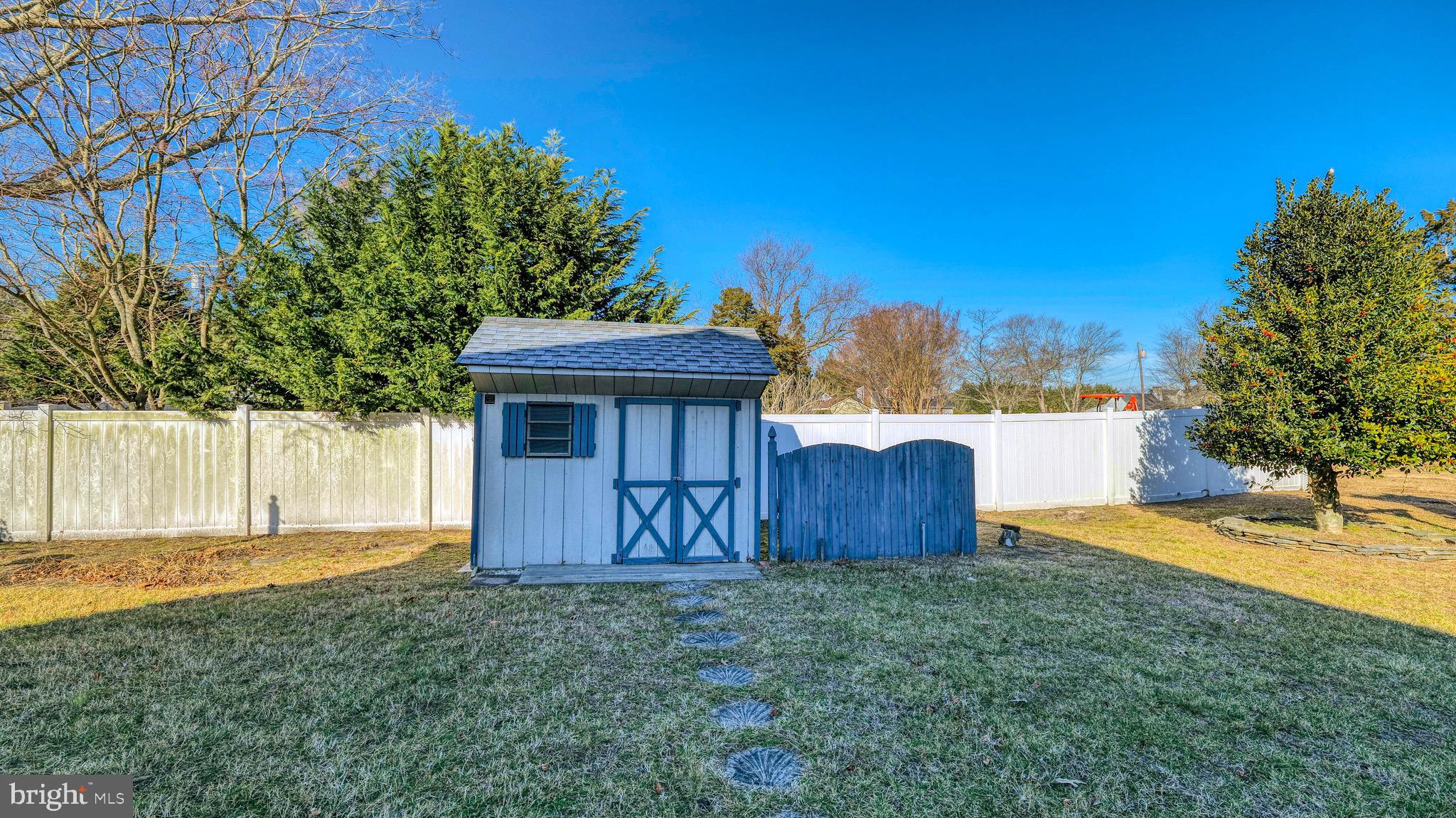 530 North Shore Road Marmora, NJ 08223 - Photo 26 of 31 a view of a backyard with a barn plants and large tree