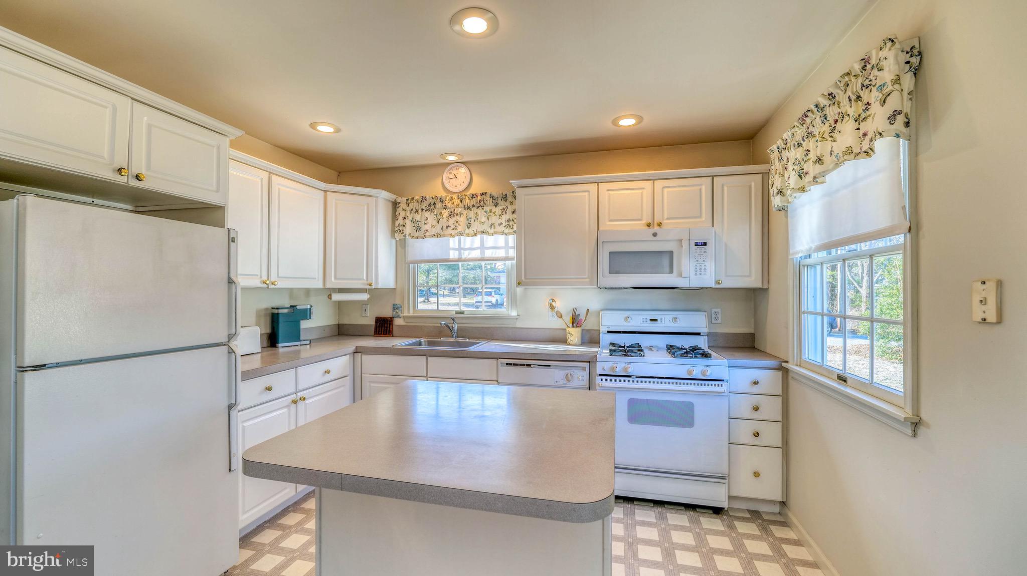 530 North Shore Road Marmora, NJ 08223 - Photo 3 of 31 a kitchen with a sink a stove a refrigerator and cabinets