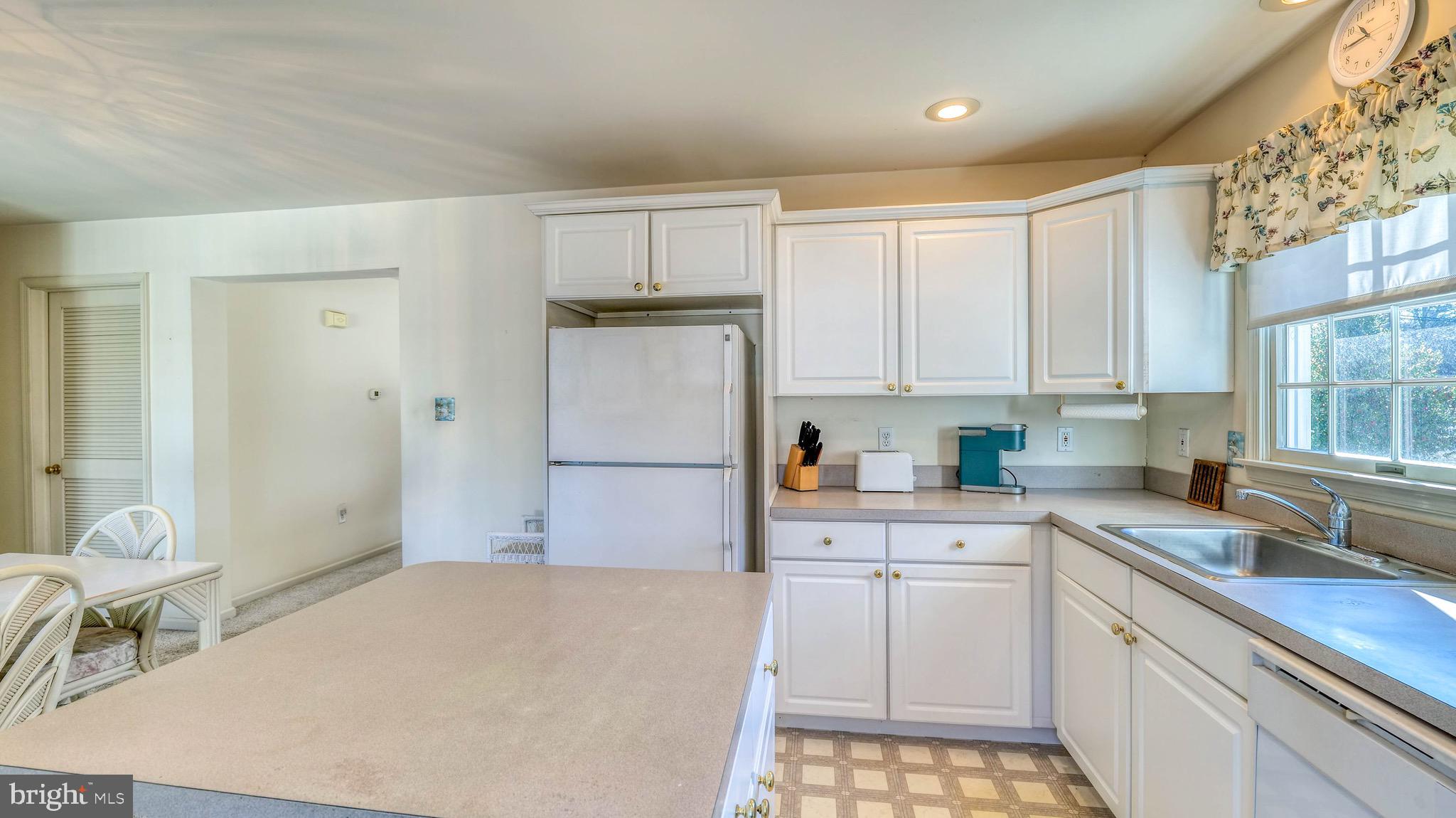 530 North Shore Road Marmora, NJ 08223 - Photo 4 of 31 a kitchen with a sink a stove a refrigerator and white cabinets