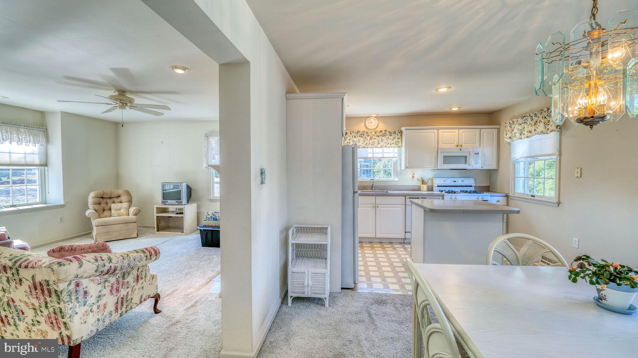 530 North Shore Road Marmora, NJ 08223 - Photo 7 of 31 a living room with furniture and a chandelier