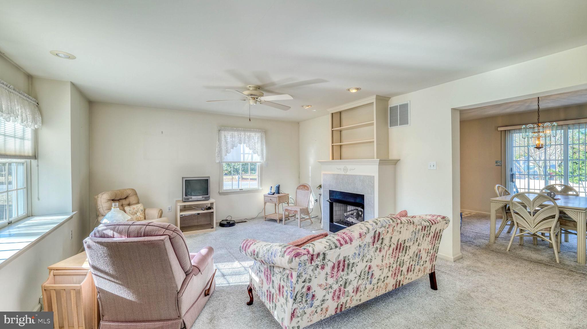 530 North Shore Road Marmora, NJ 08223 - Photo 10 of 31 a living room with furniture and a fireplace