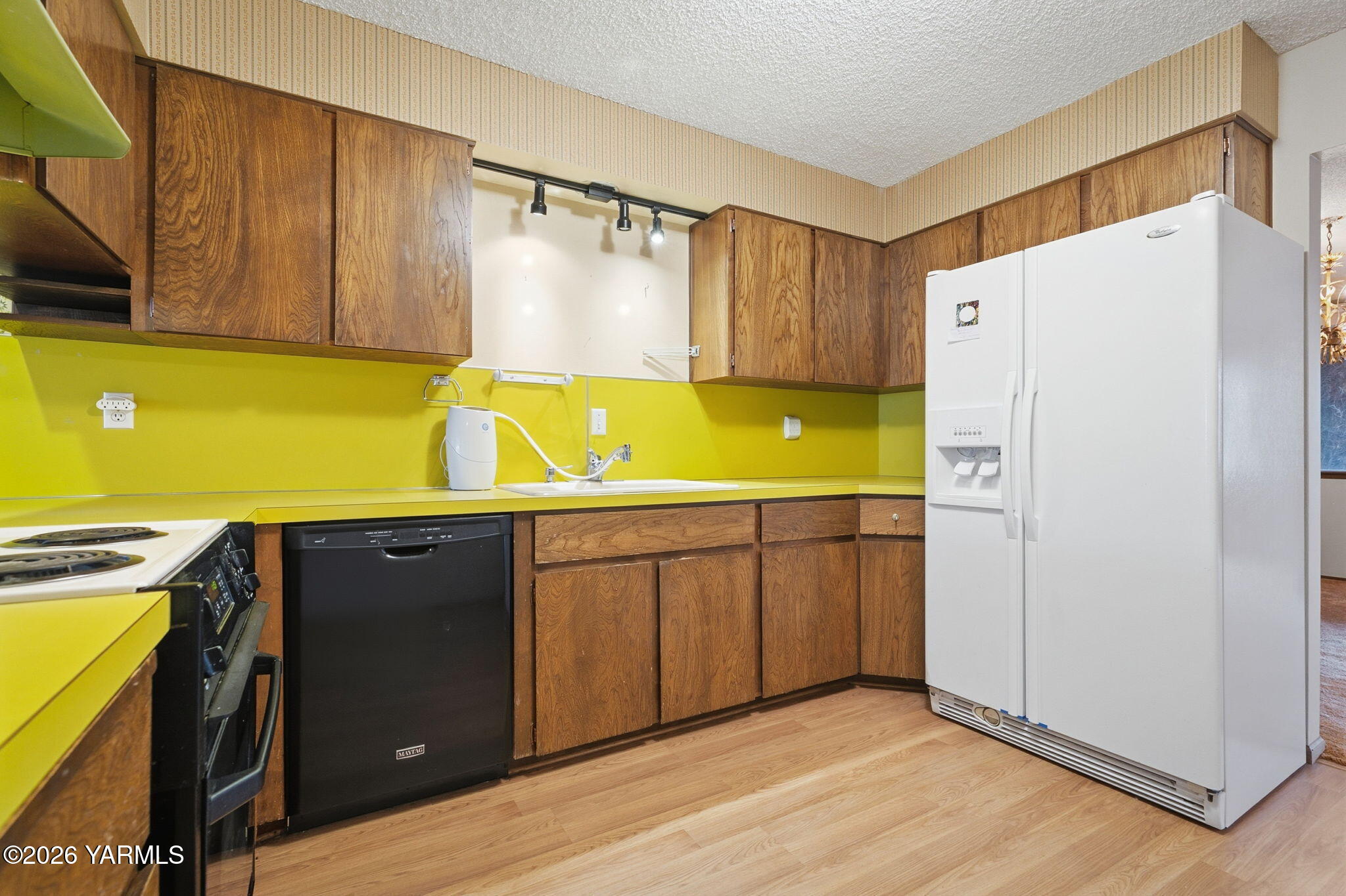 5901 Barge Street, Unit 43 Yakima, WA 98908 - Photo 12 of 22 a kitchen with a refrigerator and a sink