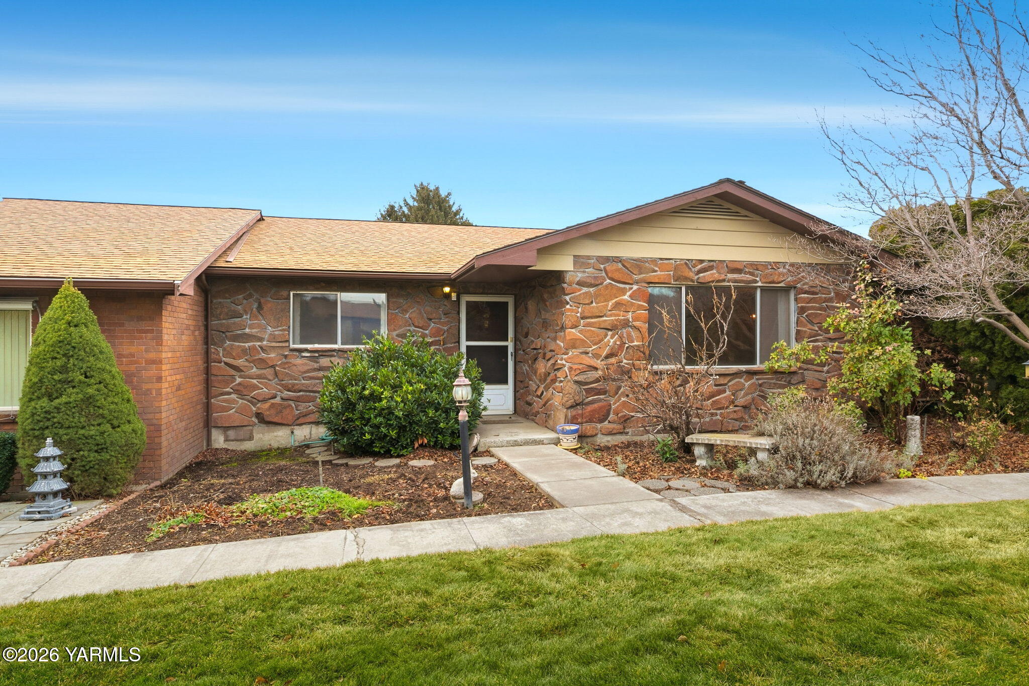 5901 Barge Street, Unit 43 Yakima, WA 98908 - Photo 2 of 22 a front view of a house with a yard