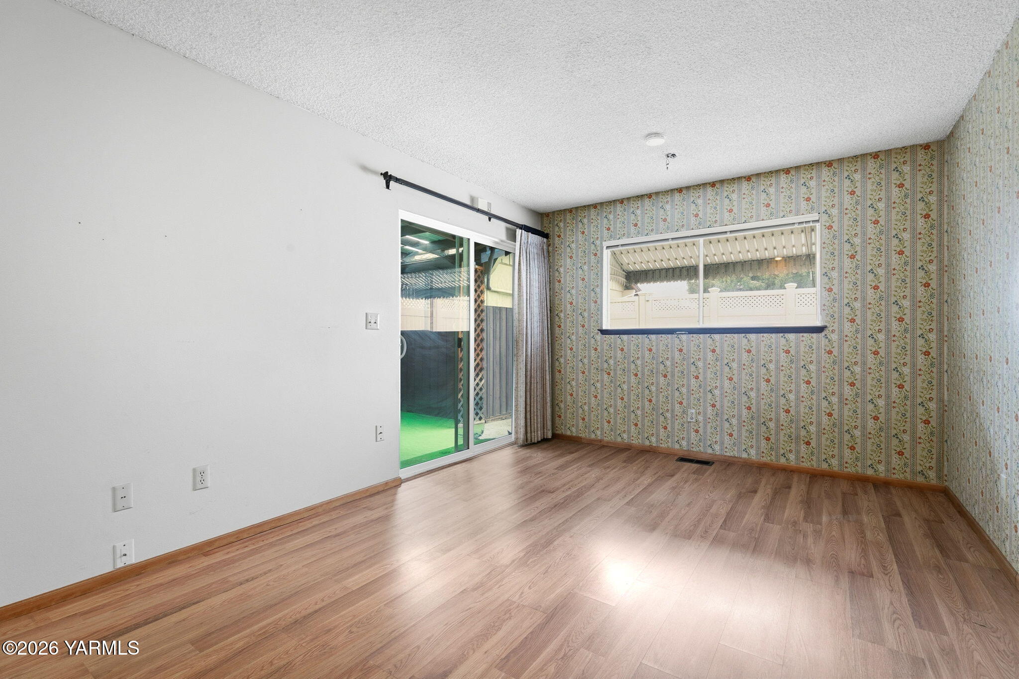 5901 Barge Street, Unit 43 Yakima, WA 98908 - Photo 8 of 22 an empty room with wooden floor and windows