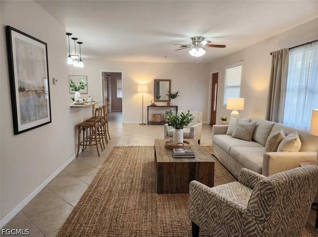 3417 19th Street Southwest Lehigh Acres, FL 33976 - Photo 2 of 14 a living room with furniture and wooden floor