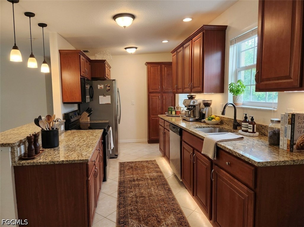 3417 19th Street Southwest Lehigh Acres, FL 33976 - Photo 3 of 14 a kitchen with kitchen island granite countertop a sink stove and refrigerator